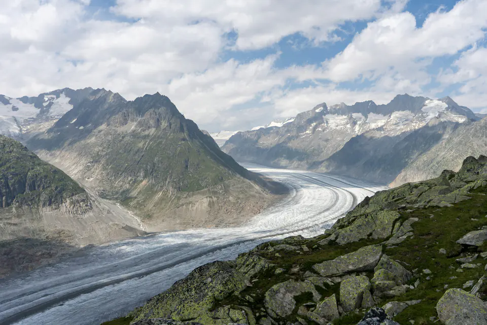 The great curve of the Aletsch Glacier under broken cloud