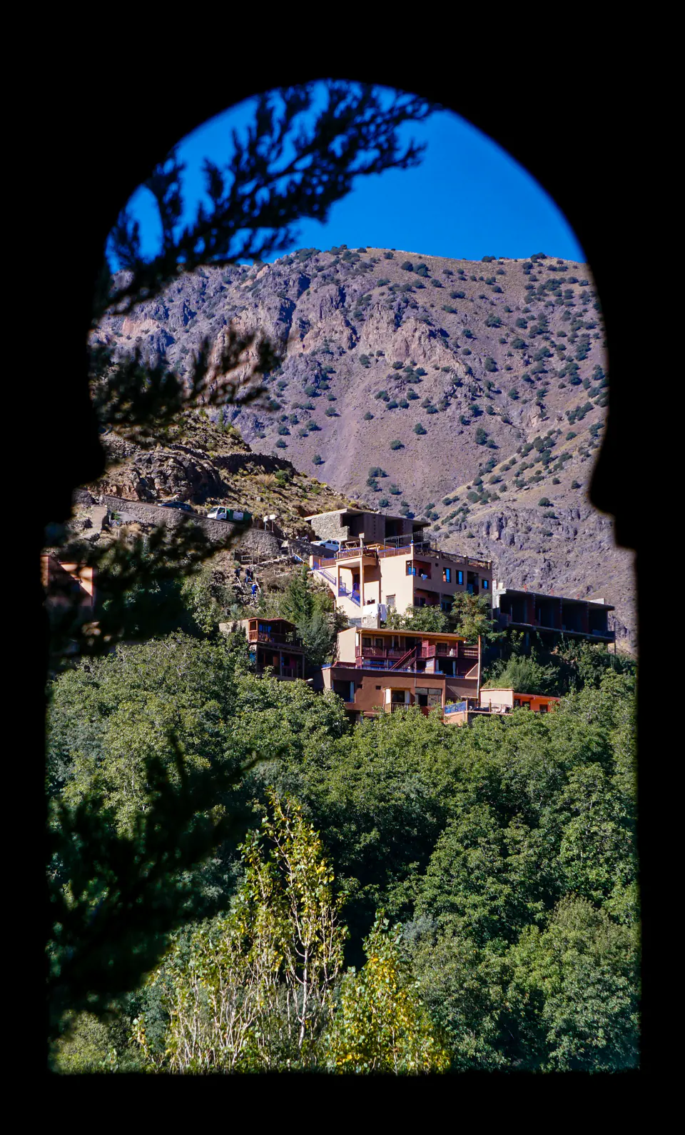 The village of Imlil in the High Atlas, seen through a stone arch