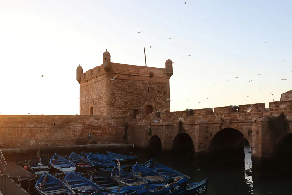 The Skala sea bastion in Essaouira in golden light, fishing boats below