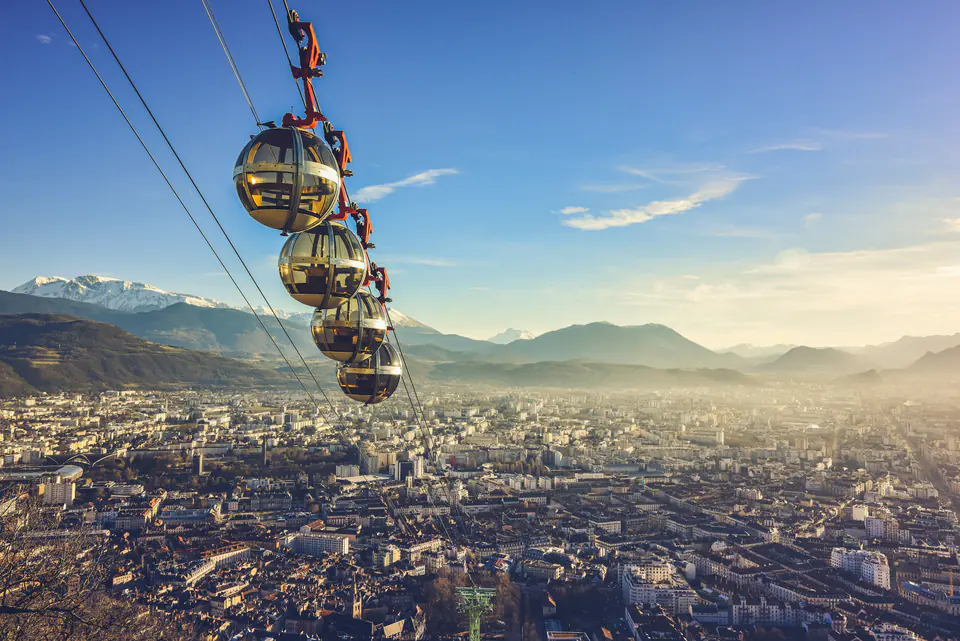 The Bastille cable cars above Grenoble, snow-capped mountains behind