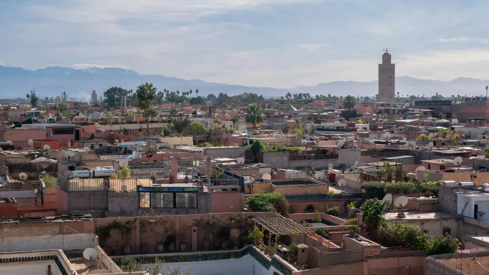 The rooftops of the Marrakech medina and the Koutoubia, the Atlas on the horizon