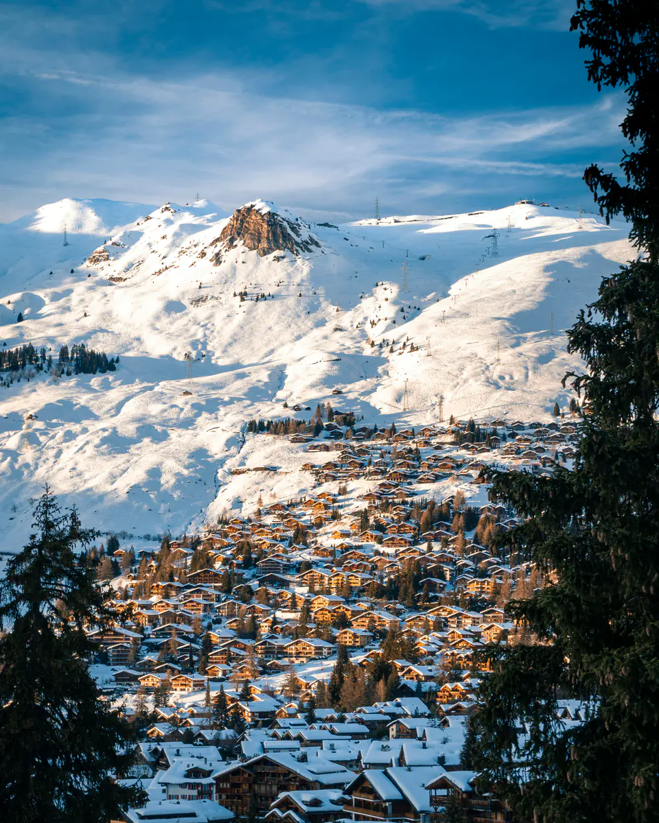 Verbier in late-afternoon light below snow-covered slopes