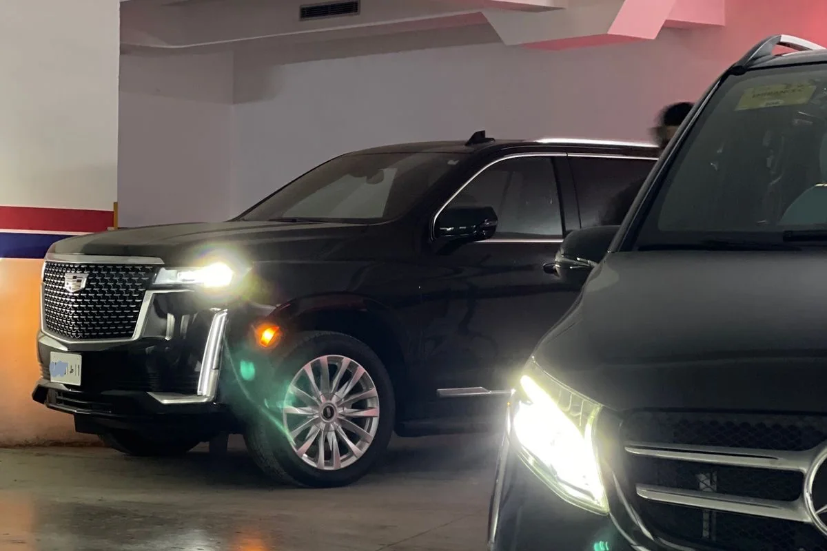 Real Cadillac Escalade and Mercedes V-Class parked in a Moroccan garage