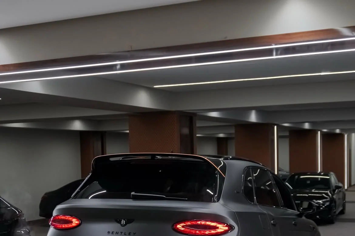 Real Accrocar Bentley inspected under garage lighting before rental