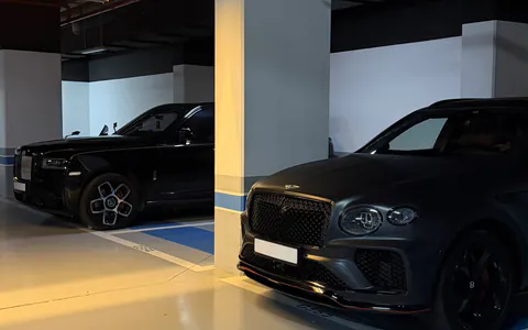 Real luxury cars parked carefully in a covered Moroccan garage