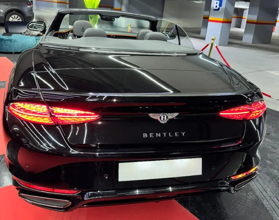 Vedere din spate a Bentley Continental GTC negru cu plafonul deschis