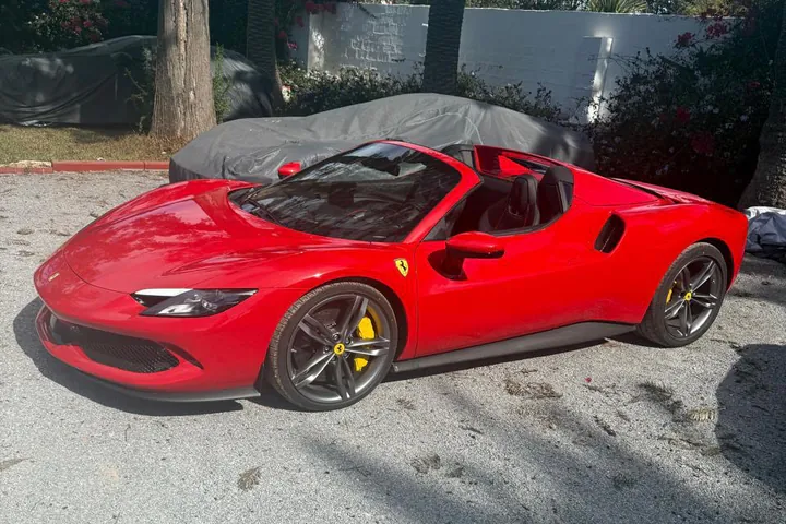 A red Ferrari 296 GTS from the Accrocar fleet